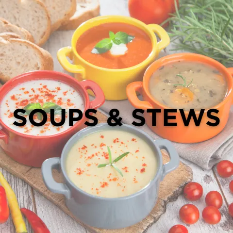 Four colorful bowls of soups and stews on a wooden board, surrounded by bread and cherry tomatoes. The text "Soups & Stews" overlays the image.